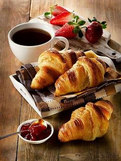 croissants with jam and strawberries on the side