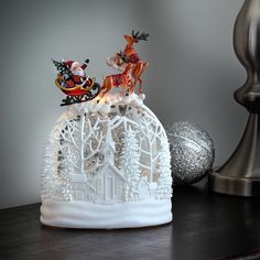 a christmas scene with santa and reindeer on top of a house