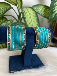 The perfect accessory for your special occasions, these  firoji   and golden Color Bangles feature Pearl and Stone detailing. Crafted with copper, these bangles are sure to add a touch of elegance and glamour to your look. Features: * Copper material *  Stone detailing *   firoji  and golden Color * Size: 2.6,2.8,2.10 Blue Bangle As A Festival Gift, Traditional Blue Bangle For Weddings, Blue Festive Bracelets For Festivals, Traditional Blue Wedding Bangle, Blue Bangle For Weddings And Festivals, Elegant Turquoise Bangle For Wedding, Blue Traditional Bangle For Festive Occasions, Blue Bohemian Bangle For Festive Occasions, Festive Blue Bangle For Festivals