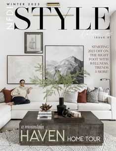 a magazine cover with a man sitting on a couch in front of a coffee table