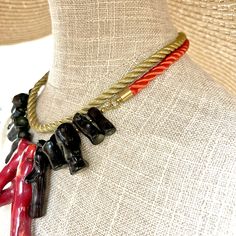 Red shiny silk cord, gold ribbon, with red and black coral. A combination of fancy colors with natural stones.  The necklace is minimalist, lightweight, and elegant.  Vibrant ribbon color with natural stones.  The necklace is 16 inches long and weighs 4 ounces. Elegant Adjustable Red Coral Beaded Necklaces, Elegant Adjustable Red Coral Necklace, Elegant Adjustable Red Coral Beaded Necklace, Red Coral Necklaces For Party, Red Coral Necklace For Party, Formal Red Coral Beaded Necklace, Red Choker Necklaces For Formal Occasions, Red Choker Necklace For Formal Occasions, Formal Red Choker Necklaces