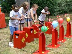 several children are playing with different colored objects