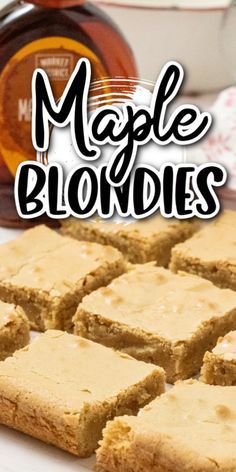 maple blondies cut into squares on top of a white plate with honey in the background