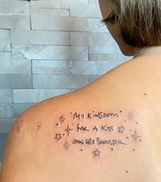 the back of a woman's shoulder with writing on it that says, my kingdom has a kiss for me shouldn