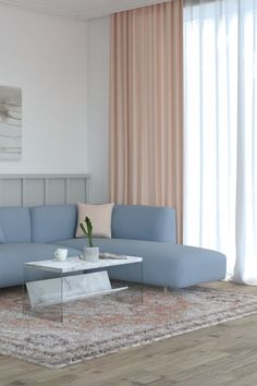 a living room with a blue sectional couch and coffee table in front of a window