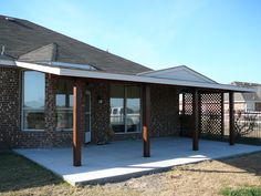 a house with a covered patio in front of it