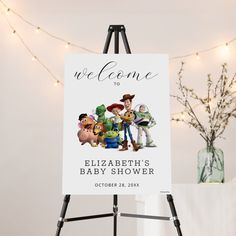 a welcome sign for a baby shower with the characters from toy story and buzz lightyear