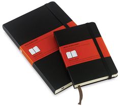 two black and red notebooks sitting next to each other