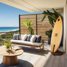 a wooden bench sitting on top of a patio next to a surfboard and potted plant