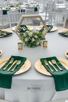 the table is set with gold and green place settings