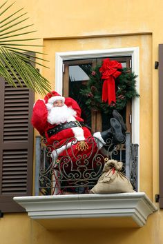 a santa clause sitting on top of a window sill