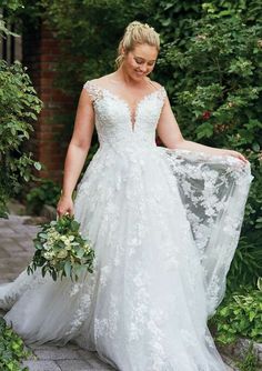 a woman in a white wedding dress holding a bouquet