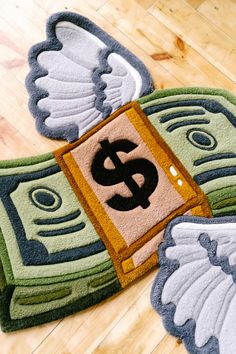 three rugs with dollar signs on them sitting on a wooden floor next to each other