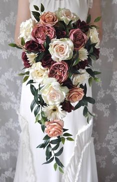 a bride holding a bouquet of flowers in her hands