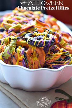 halloween chocolate pretzel bites in a white dish on top of a tablecloth