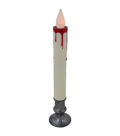 a white candle with red blood dripping down the middle and on it's side