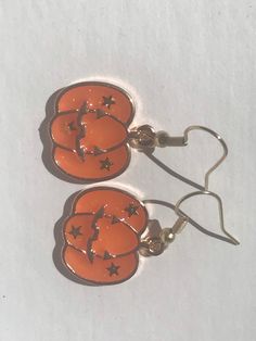 Cute gold and orange earrings featuring a carved pumpkin. Earring wires are hypoallergenic. Gold And Orange, Orange Jewelry, Spooky Fall, Fall Orange, Carved Pumpkin, Jack O'lantern, Earrings Halloween, Orange Earrings, Earring Wires