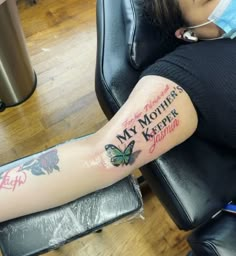 a woman with a tattoo on her arm that says, my mother is keeper and butterfly