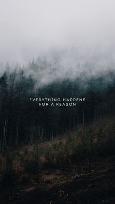 the words everything happens for a reason written in white on a foggy forest background