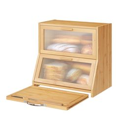 a wooden box with two glass doors on the front and bottom, filled with bread