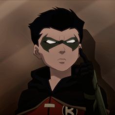 an animated image of a man with green eyes and a black cape on his head