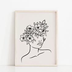 a black and white drawing of a woman with flowers in her hair