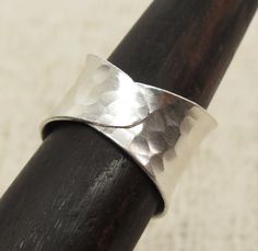 "Handmade Hammered Sterling Silver wide concave band Ring, Adjustable Wrap Band, Shiny finish *Width (top side): 9/16 inches (0.6\") / 1.5cm Metal Purity: 95% Silver (Purer than 925 Sterling Silver) Wider version (1.1\" / 2.8cm): https://www.etsy.com/listing/185404378 Medium version (0.85\" / 2.1cm): https://www.etsy.com/listing/578056282 We also have Matching style Cuffs: https://www.etsy.com/listing/256824170 https://www.etsy.com/listing/173665269 To browse some more of our Silver Jewelry coll Handmade Wide Band Ring For Promise, Adjustable Thick Band Wide Ring Gift, Adjustable Thick Band Wide Ring As Gift, Adjustable Thick Band Sterling Silver Ring, Handmade Adjustable Wide Band Promise Ring, Adjustable Wide Band Ring As Gift, Silver Adjustable Wide Band, Adjustable Wide Band Ring For Anniversary, Adjustable Wide Band In Silver