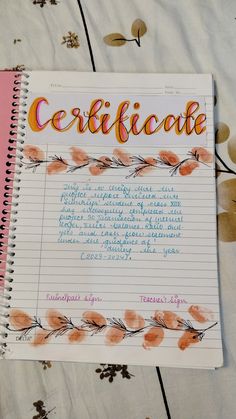 a spiral notebook with the words certificate written in cursive writing on top of it