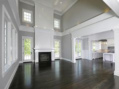 an empty living room with wood flooring and white trim on the walls is shown