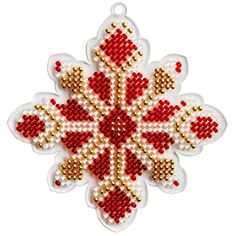 a red and white beaded snowflake ornament on a white background