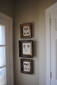 three framed pictures hanging on the wall above a door with spoons and utensils