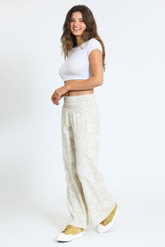 Step into effortless style with the Wide Smocked Boardwalk Pant in Sand. Designed for both comfort and versatility, these pants are perfect for a day at the beach or a casual outing in the city. Key Features Fabric Contents: Crafted from a premium blend of 55% Linen and 45% Rayon, these pants offer a breathable and lightweight feel, making them ideal for warm weather. Distinctive Smocked Waistband: The smocked waistband ensures a comfortable fit that adapts to your body, providing both style and Tie Waist Pants, Skirt Crop, A Day At The Beach, Day At The Beach, Tops For Leggings, Cropped Jeans, Jogger Pants, Jeans Shop, Short Tops