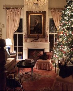 a living room with a christmas tree in the corner and a painting on the wall