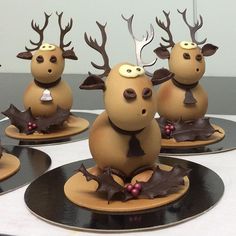 five reindeer figurines sitting on top of black plates