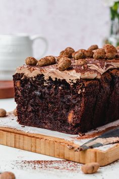 a piece of chocolate cake sitting on top of a cutting board