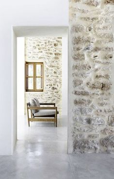 an image of a room with stone walls and flooring on the right side of the photo