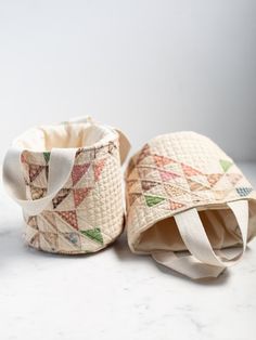 two small baskets sitting on top of a white counter