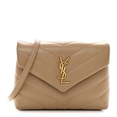 This is an authentic SAINT LAURENT Calfskin Y Quilted Monogram Toy Loulou Crossbody Bag in Latte. This elegant shoulder bag is crafted of chic chevron quilted calfskin leather in beige. The bag features a leather shoulder strap and gold hardware. The front flap features a prominent gold YSL monogram detail and opens to a partitioned black fabric interior with zipper and patch pockets. Chevron Quilt, Dark Beige, Free Bag, Black Fabric, Gold Hardware, Patch Pocket, Calf Skin, Saint Laurent, Crossbody Bag