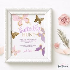 a white frame with pink and gold butterflies on it, next to some dried flowers