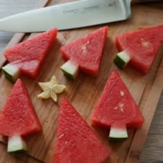 slices of watermelon are arranged on a cutting board with a knife next to them