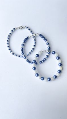 three bracelets with blue beads and white pearls