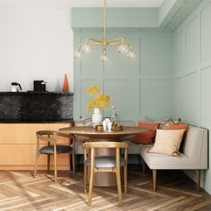 a dining room table with two chairs and a bench in front of the counter top