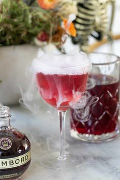 a bottle of booze next to a glass filled with liquid