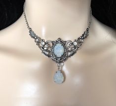 "Choker: This elegantly ornate necklace is made with antique silver tone centerpieces, featuring lavish baroque details. Its mesmerizing design is accented with dazzling white opal glass crystals/jewels. Necklace length is adjustable 14\"-17\" with soldered stainless steel cable chain, lobster clasp and extender. Decorated portion is 4\" wide and 2 1/2\" tall in the very center. If you would like a different length, please send us a message. Earrings: These dainty and elegantly ornate earrings a White Gothic Metal Necklace, Ornate Baroque Silver Jewelry, Ornate White Metal Jewelry, Ornate Silver Baroque Necklaces, Victorian White Necklace With Intricate Design, Victorian Necklace With Intricate Design In White, White Victorian Baroque Jewelry, Ornate Silver Bridal Necklace, Gothic Antique