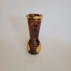 a wooden vase sitting on top of a white table