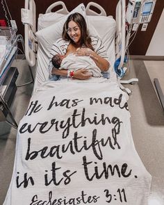 a woman laying in a hospital bed with a blanket that says it has made everything beautiful in its time