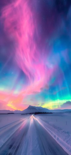 an image of the aurora bore in the sky over snow covered ground with trees and mountains