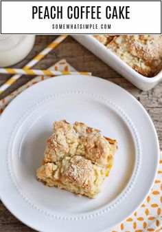 two pieces of coffee cake on a white plate next to a yellow and white napkin