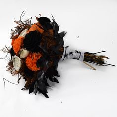 a bridal bouquet with black and orange flowers