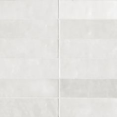 a white tile wall with horizontal lines on it